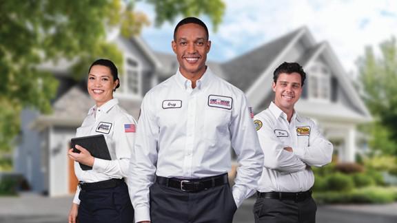 A group of people standing in front of a house