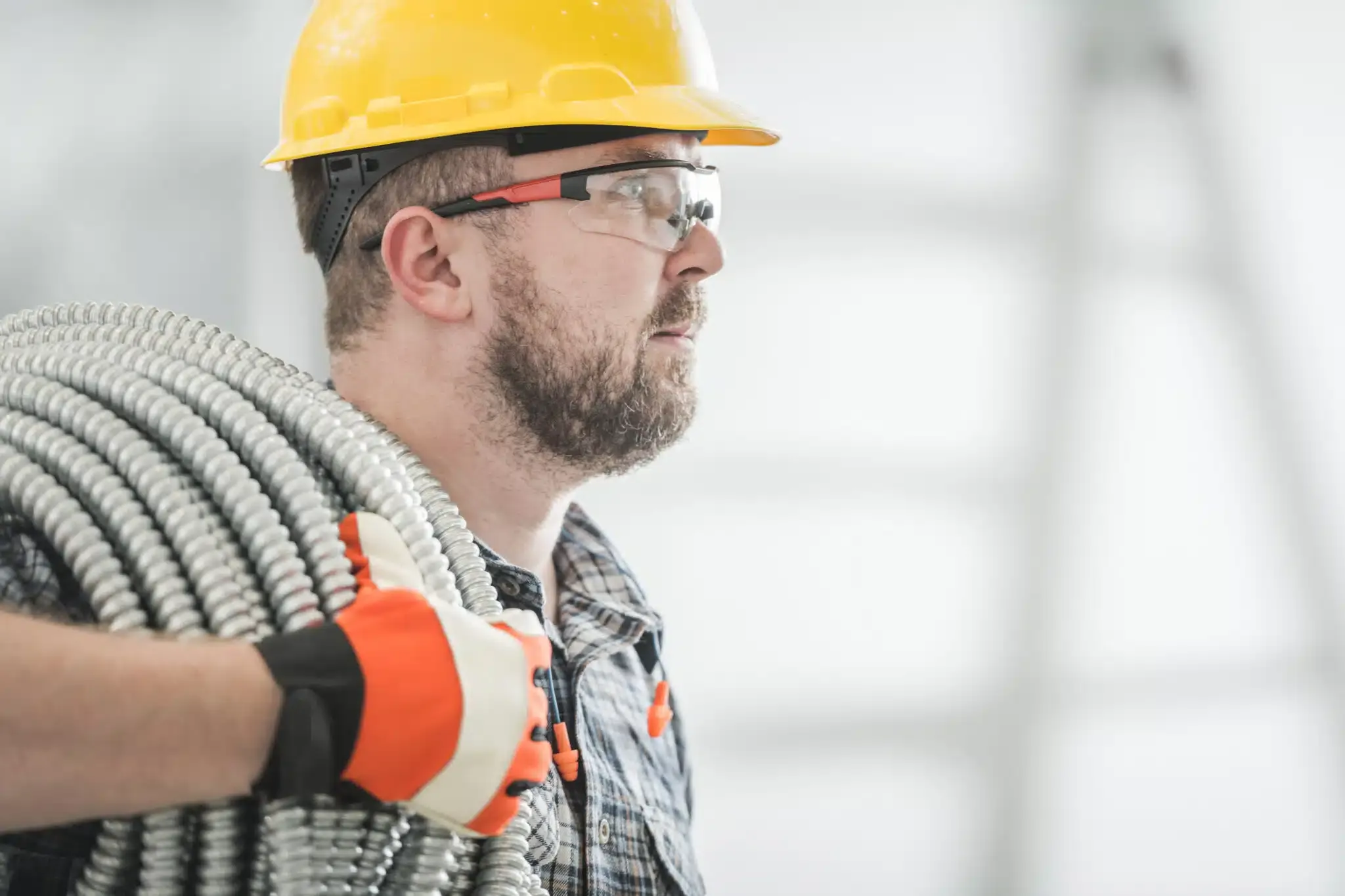 electrician carrying bendable conduit