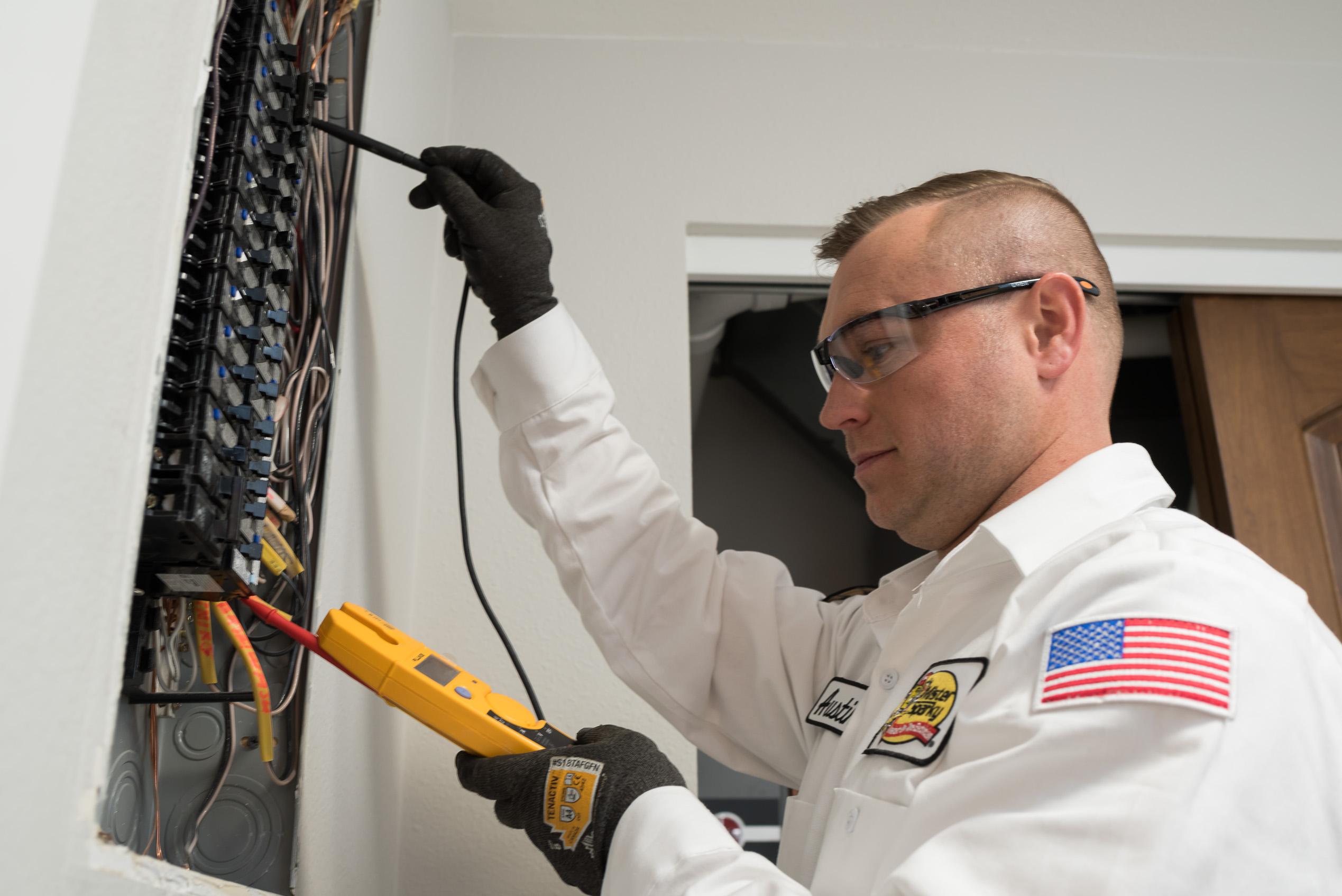 An Arizona electrician from Mister Sparky inspects a home’s electrical system