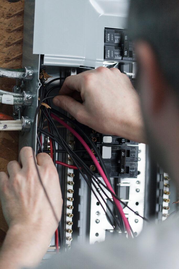 hands working on electrical wires