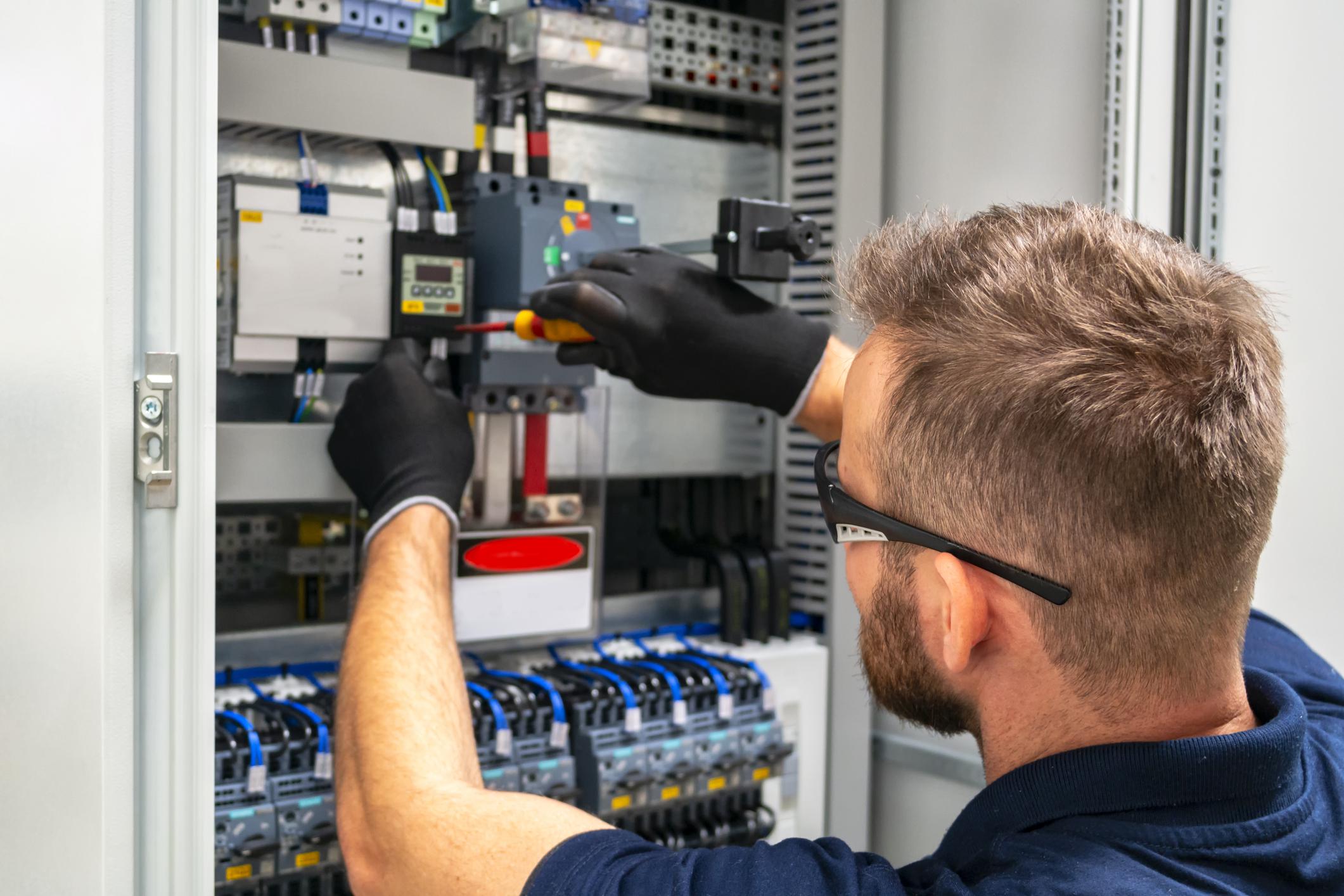 man working on electrical panel