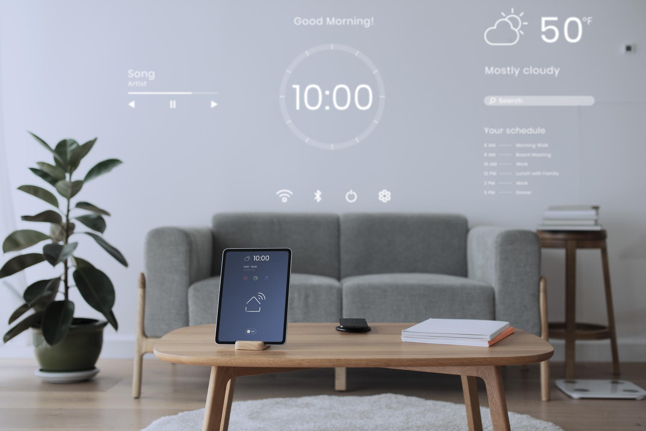 Digital tablet screen with smart home controller on a wooden table 