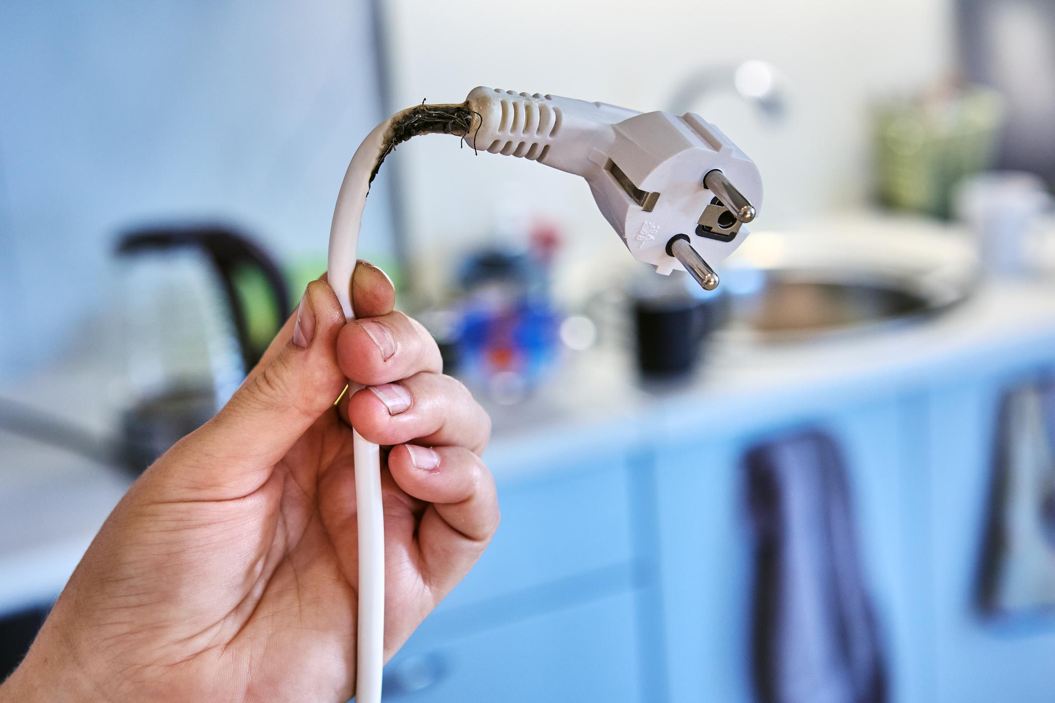 Extension cord melted and charred due to overload and could cause fire