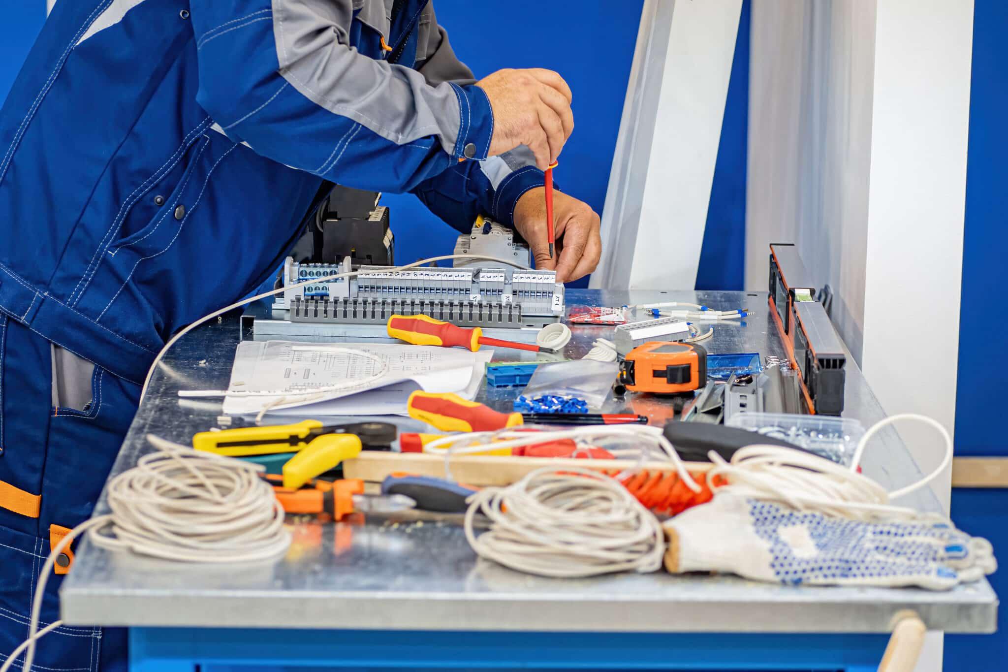 person using electrical device to test circuit
