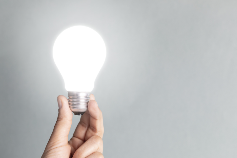 hand holding light bulb
