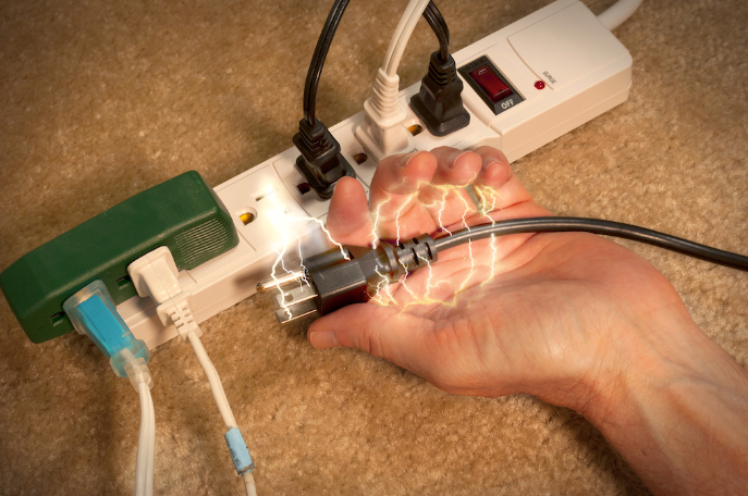 shocked hand holding a cord